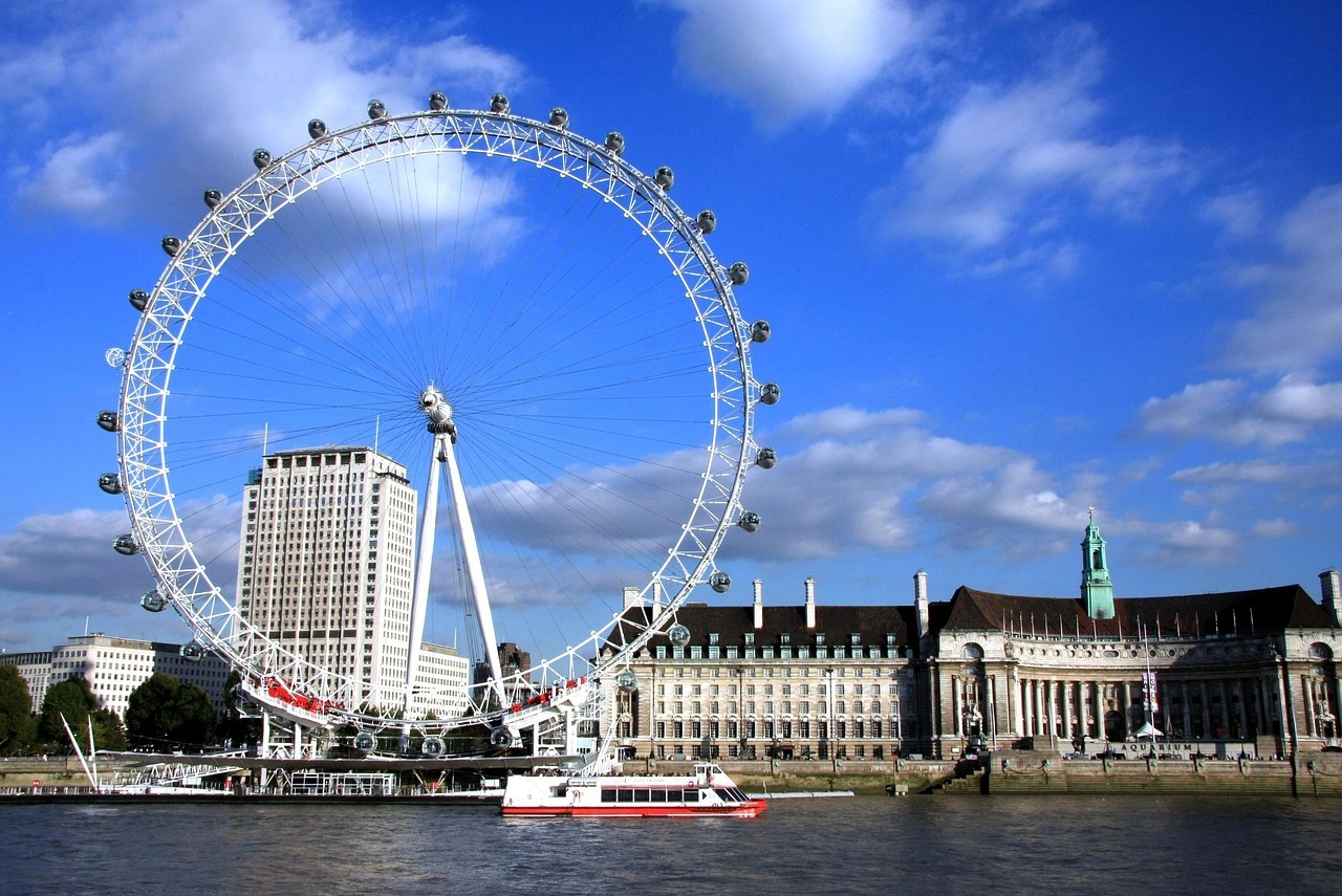The London Eye, a large Ferris wheel, stands tall against the skyline, offering panoramic views of the city